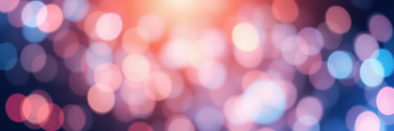 Colorful bokeh lights creating a vibrant atmosphere during a celebration or event in a dark setting